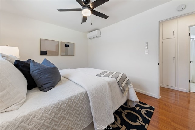 5536 Linden Ave, Long Beach, CA 90805 - bedroom featuring baseboards, ceiling fan, a wall unit AC, and light wood-style flooring