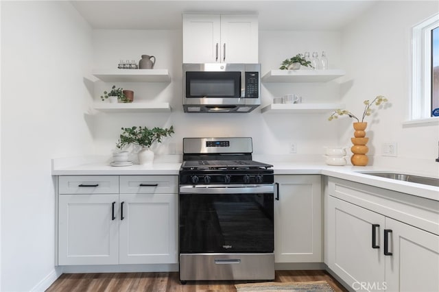 5536 Linden Ave, Long Beach, CA 90805 - kitchen featuring open shelves, light countertops, a sink, dark wood finished floors, and stainless steel appliances
