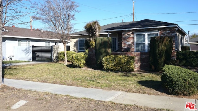 ranch-style home with a front lawn