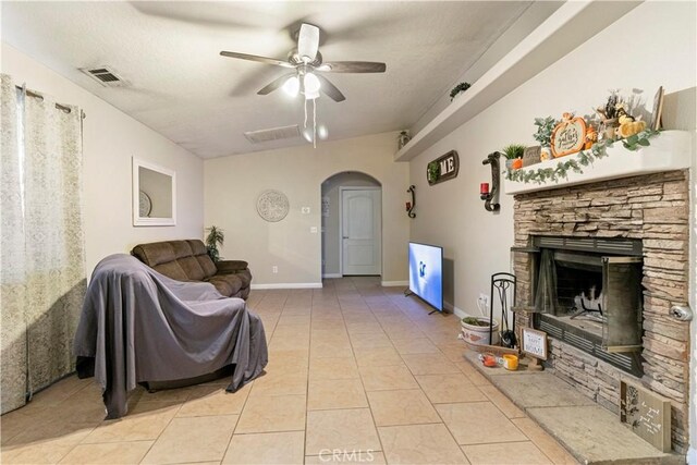 21246 Wren St, Apple Valley, CA 92308 - living area with visible vents, arched walkways, a fireplace, light tile patterned floors, and ceiling fan