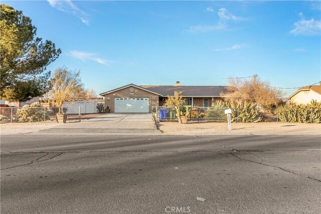 21246 Wren St, Apple Valley, CA 92308 - ranch-style house with a fenced front yard, driveway, an attached garage, and a chimney