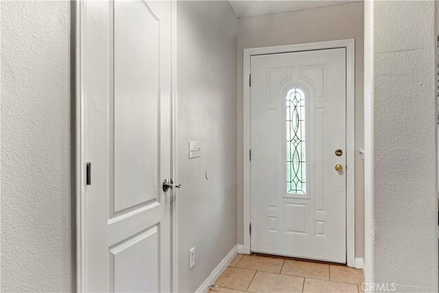 21246 Wren St, Apple Valley, CA 92308 - entrance foyer with light tile patterned flooring, baseboards, and a textured wall