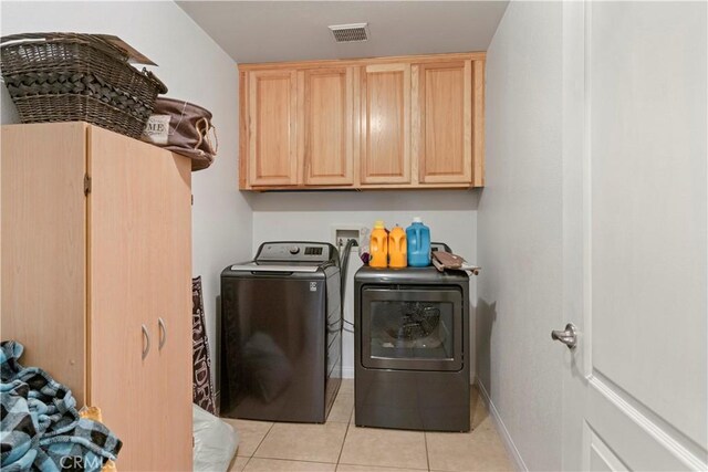 21246 Wren St, Apple Valley, CA 92308 - laundry area featuring baseboards, visible vents, light tile patterned flooring, cabinet space, and washer and clothes dryer