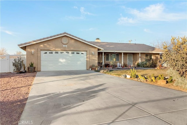 21246 Wren St, Apple Valley, CA 92308 - ranch-style home featuring stucco siding, a garage, driveway, and fence