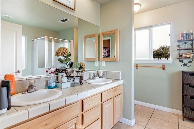 21246 Wren St, Apple Valley, CA 92308 - bathroom with double vanity, tile patterned floors, a stall shower, and a sink