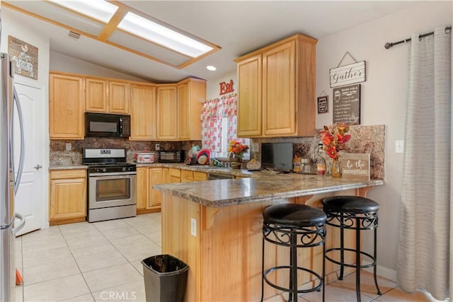 21246 Wren St, Apple Valley, CA 92308 - kitchen featuring light tile patterned floors, appliances with stainless steel finishes, a peninsula, and light brown cabinets