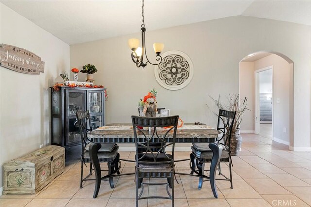 21246 Wren St, Apple Valley, CA 92308 - dining room with light tile patterned floors, baseboards, an inviting chandelier, arched walkways, and vaulted ceiling