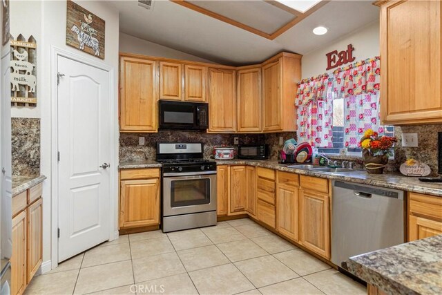 21246 Wren St, Apple Valley, CA 92308 - kitchen with lofted ceiling, light tile patterned flooring, appliances with stainless steel finishes, and a sink