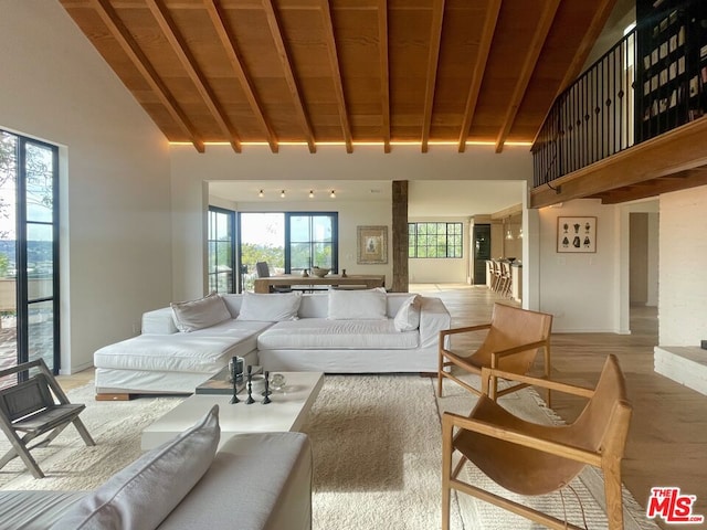 living room with high vaulted ceiling, wooden ceiling, beam ceiling, and light hardwood / wood-style floors