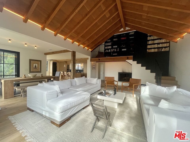 living room featuring hardwood / wood-style flooring, wood ceiling, high vaulted ceiling, and beamed ceiling