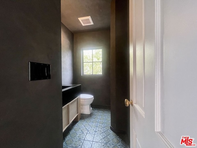 bathroom featuring toilet and vanity