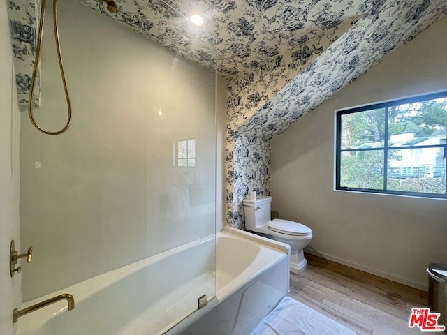 bathroom with toilet, independent shower and bath, and hardwood / wood-style floors