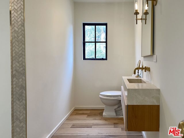 bathroom featuring hardwood / wood-style floors, toilet, and vanity