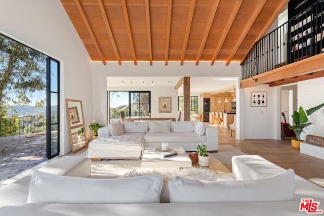 living room featuring wood ceiling, high vaulted ceiling, beam ceiling, and wood-type flooring