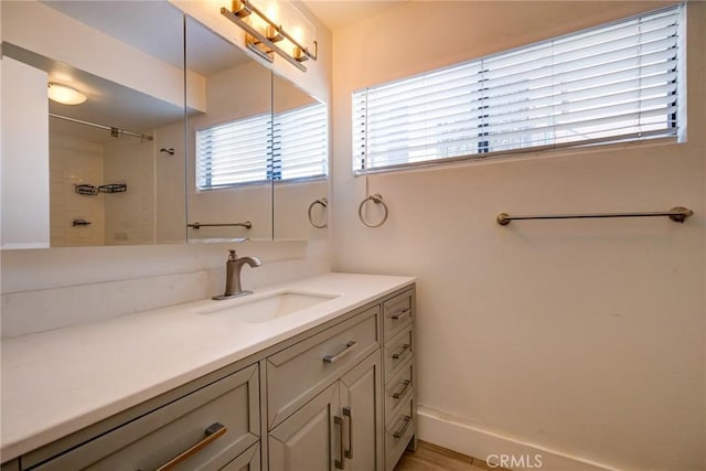 bathroom with vanity and a tile shower