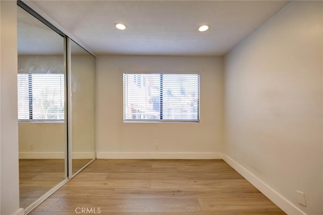 unfurnished bedroom featuring a closet and light hardwood / wood-style flooring