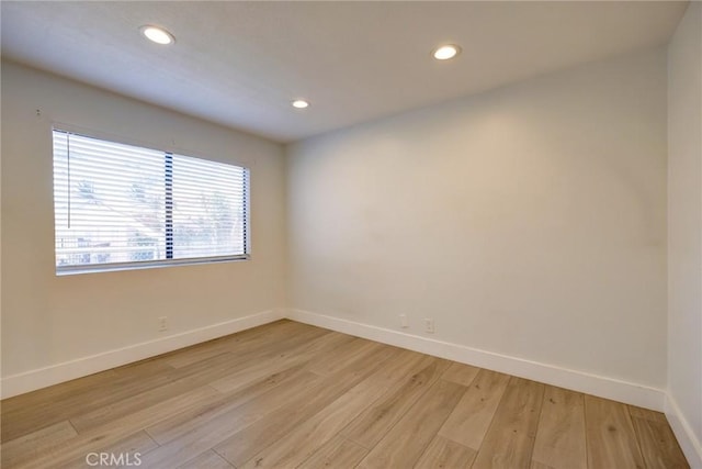 spare room with light wood-type flooring