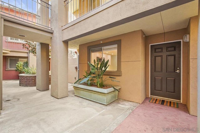 property entrance featuring a patio area and a balcony