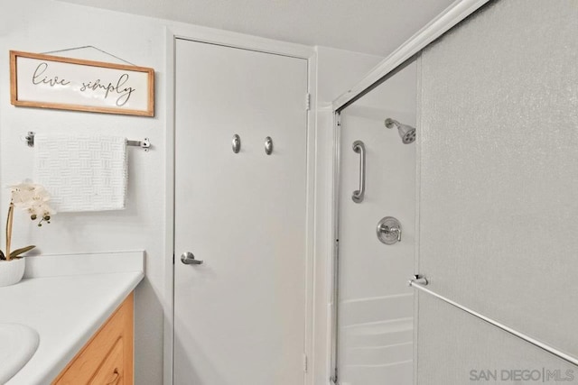 bathroom with an enclosed shower and vanity