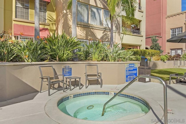 view of swimming pool with a patio area and a community hot tub