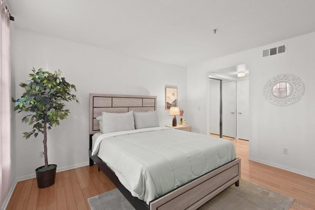 bedroom with a closet and light wood-type flooring