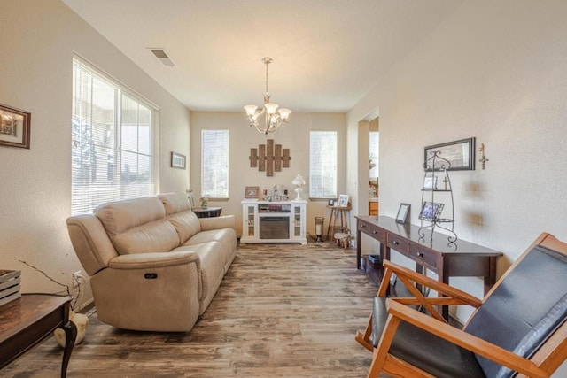 living room featuring hardwood / wood-style flooring and a notable chandelier