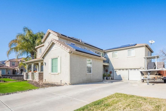 view of property exterior with solar panels and a garage