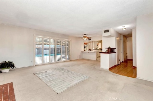 living room with light carpet and ceiling fan