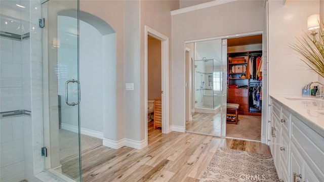 bathroom featuring vanity, hardwood / wood-style floors, and walk in shower