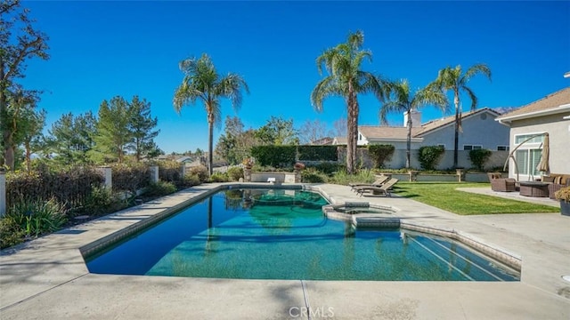 view of swimming pool featuring a patio area and an in ground hot tub