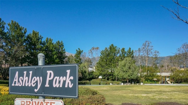 community / neighborhood sign with a yard