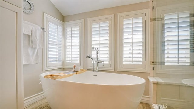 bathroom with wood-type flooring and a bathing tub