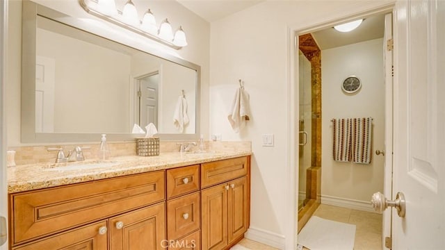 bathroom with tile patterned floors, walk in shower, and vanity