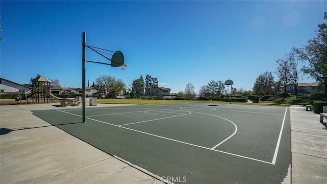 view of sport court with a playground