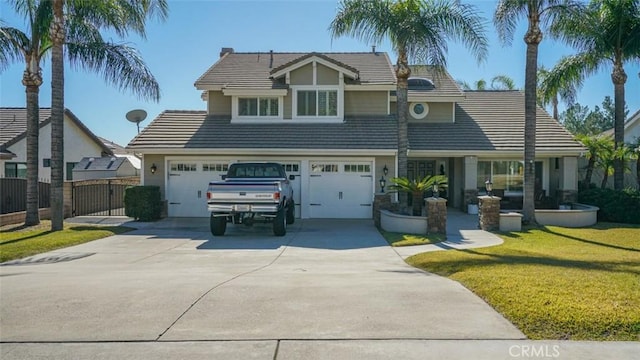 view of front of property featuring a front lawn and a garage