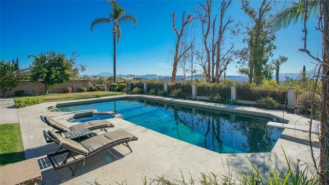 view of pool featuring an in ground hot tub and a patio