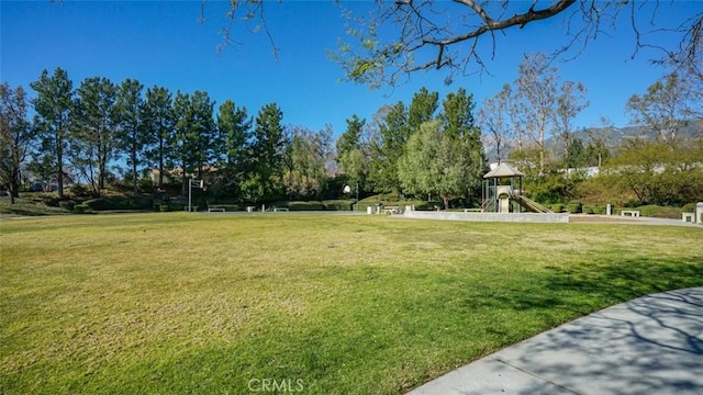 view of community with a playground and a lawn