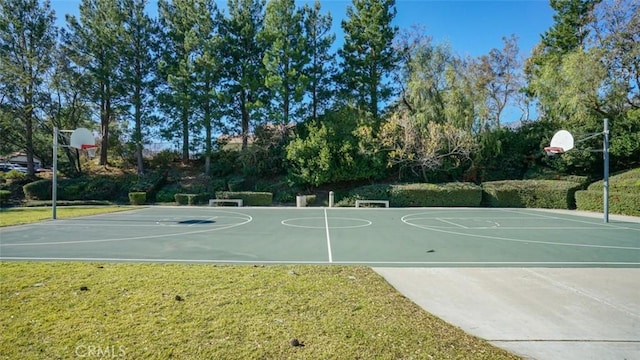 view of sport court with a yard