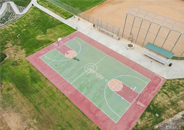 view of sport court featuring a lawn