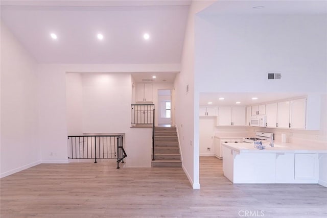 interior space with hardwood / wood-style flooring and a towering ceiling