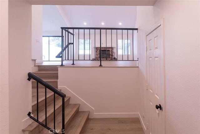 stairs with hardwood / wood-style flooring