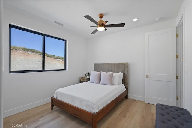 bedroom with ceiling fan and light hardwood / wood-style flooring