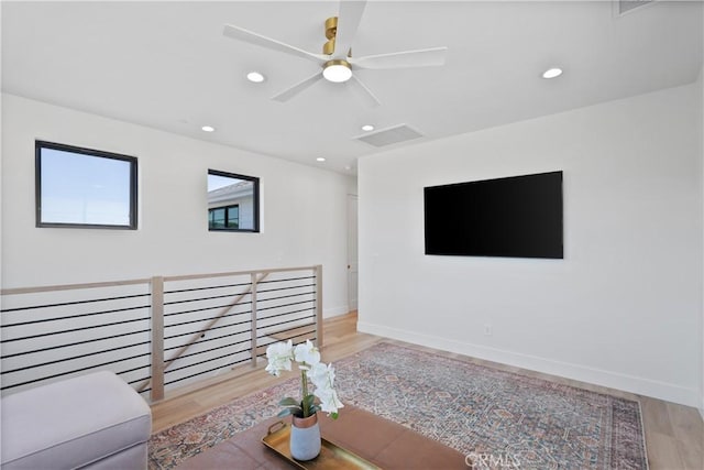 living room with light wood-type flooring and ceiling fan