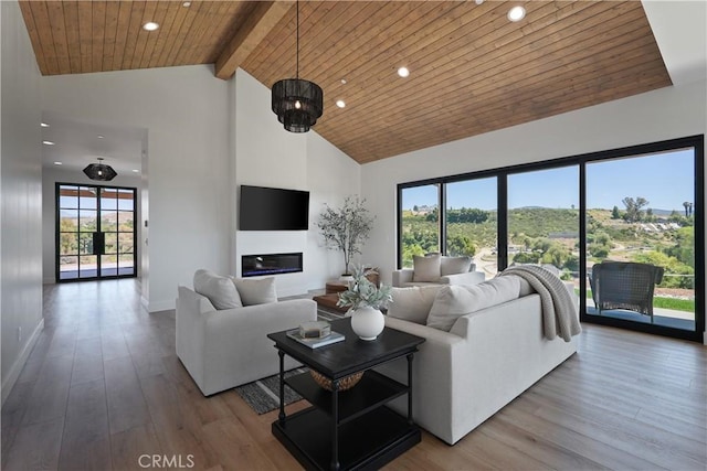 living room with an inviting chandelier, wood ceiling, wood-type flooring, high vaulted ceiling, and beamed ceiling