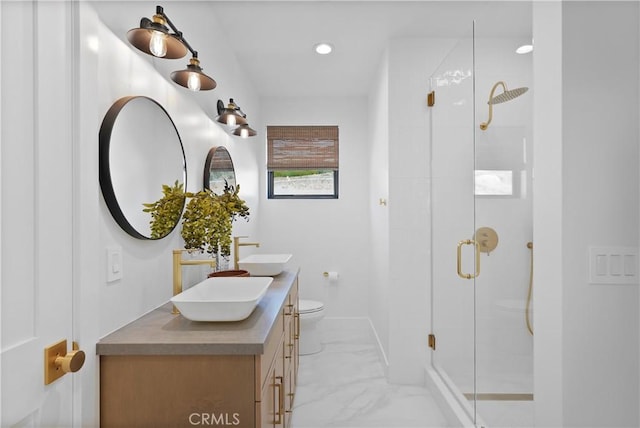 bathroom featuring toilet, vanity, and walk in shower