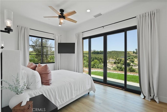 bedroom with ceiling fan, light hardwood / wood-style floors, and access to outside