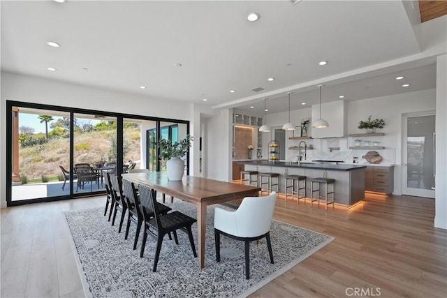 dining space featuring hardwood / wood-style flooring and sink