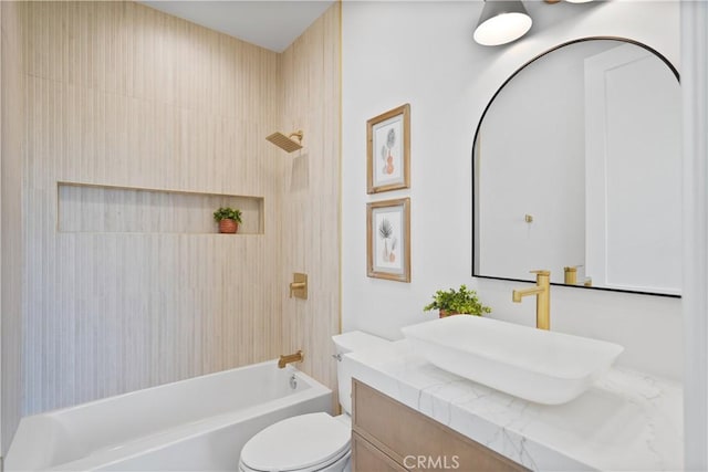 full bathroom with toilet, vanity, and tiled shower / bath combo