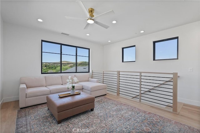 living room featuring ceiling fan and hardwood / wood-style floors