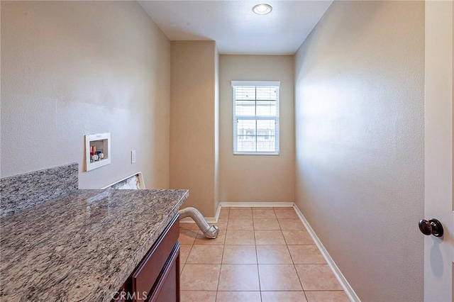 clothes washing area with cabinets, light tile patterned floors, and hookup for a washing machine